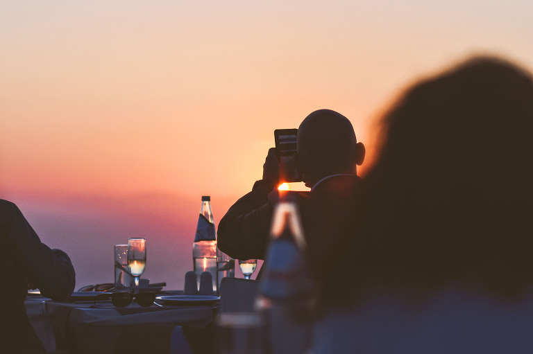 sunset dinner in santorini, greece! more photos in the journal: https://greymoss.com/santorini-greece-arrival-spectacular-sunset/ 